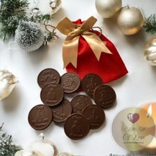 Festive themed chocolate coins and red hessian sack and gold bow